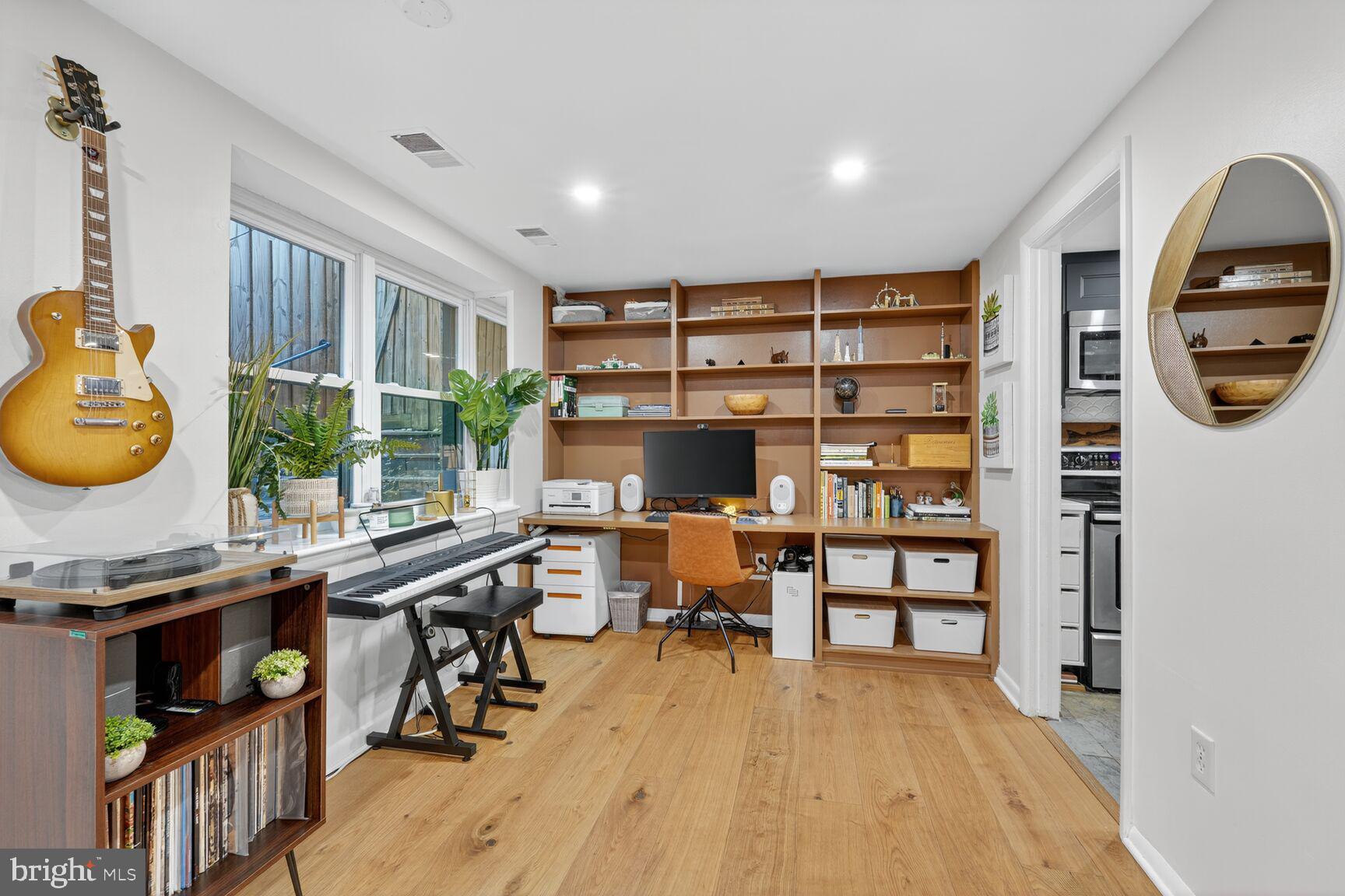 2012 O Street Northwest, Unit 12 Washington, DC 20036 - Photo 4 of 16 a view of a workspace with furniture and a large window