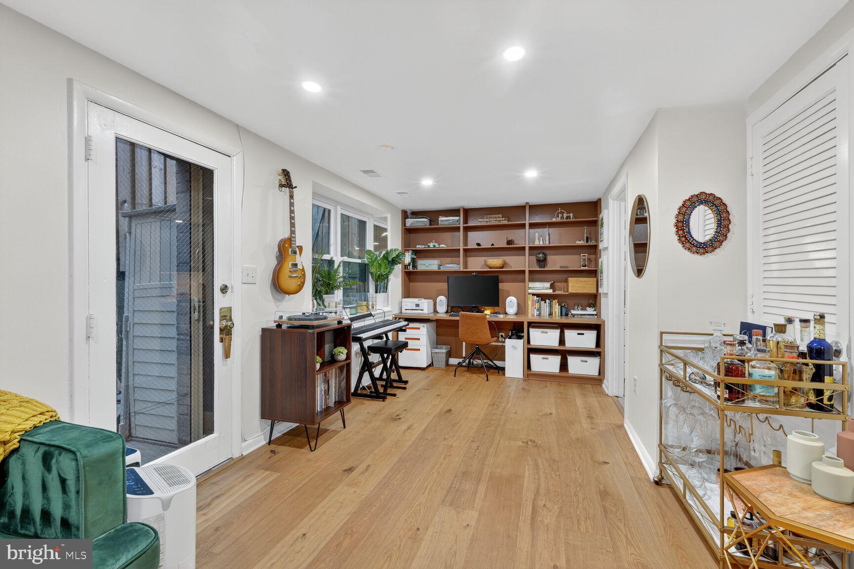 2012 O Street Northwest, Unit 12 Washington, DC 20036 - Photo 6 of 16 a living room with lots of furniture and gym equipment