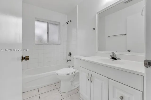 a bathroom with a bathtub a sink a toilet and a mirror