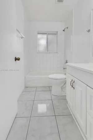 a bathroom with a bathtub and shower