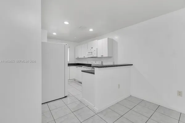 a view of kitchen with white cabinets