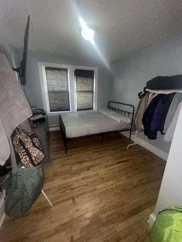 a bedroom with furniture and a wooden floor