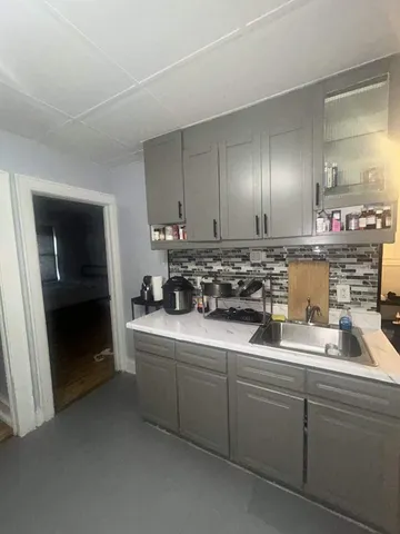 a kitchen with sink and cabinets