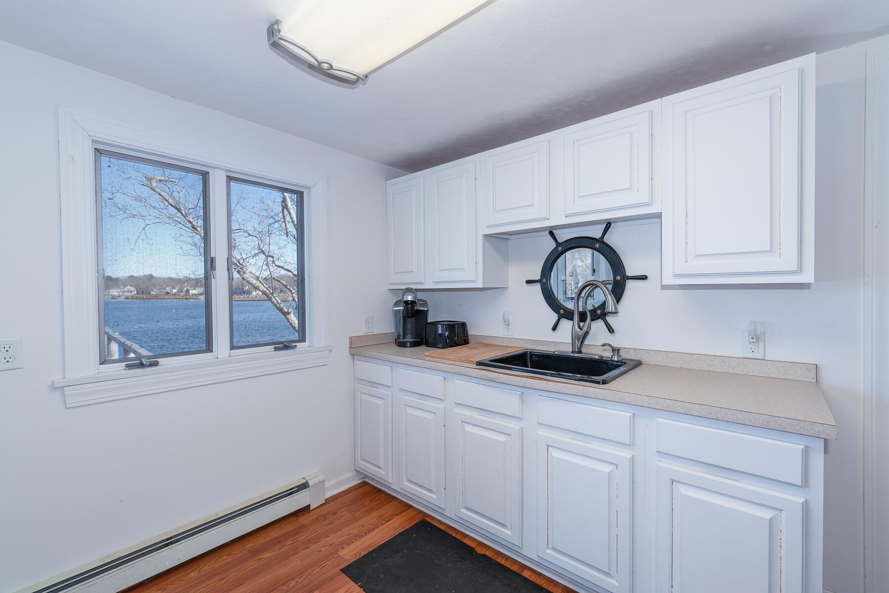 18 Great River Road Mashpee, MA 02649 - Photo 12 of 31 a kitchen with stainless steel appliances granite countertop a sink window and cabinets