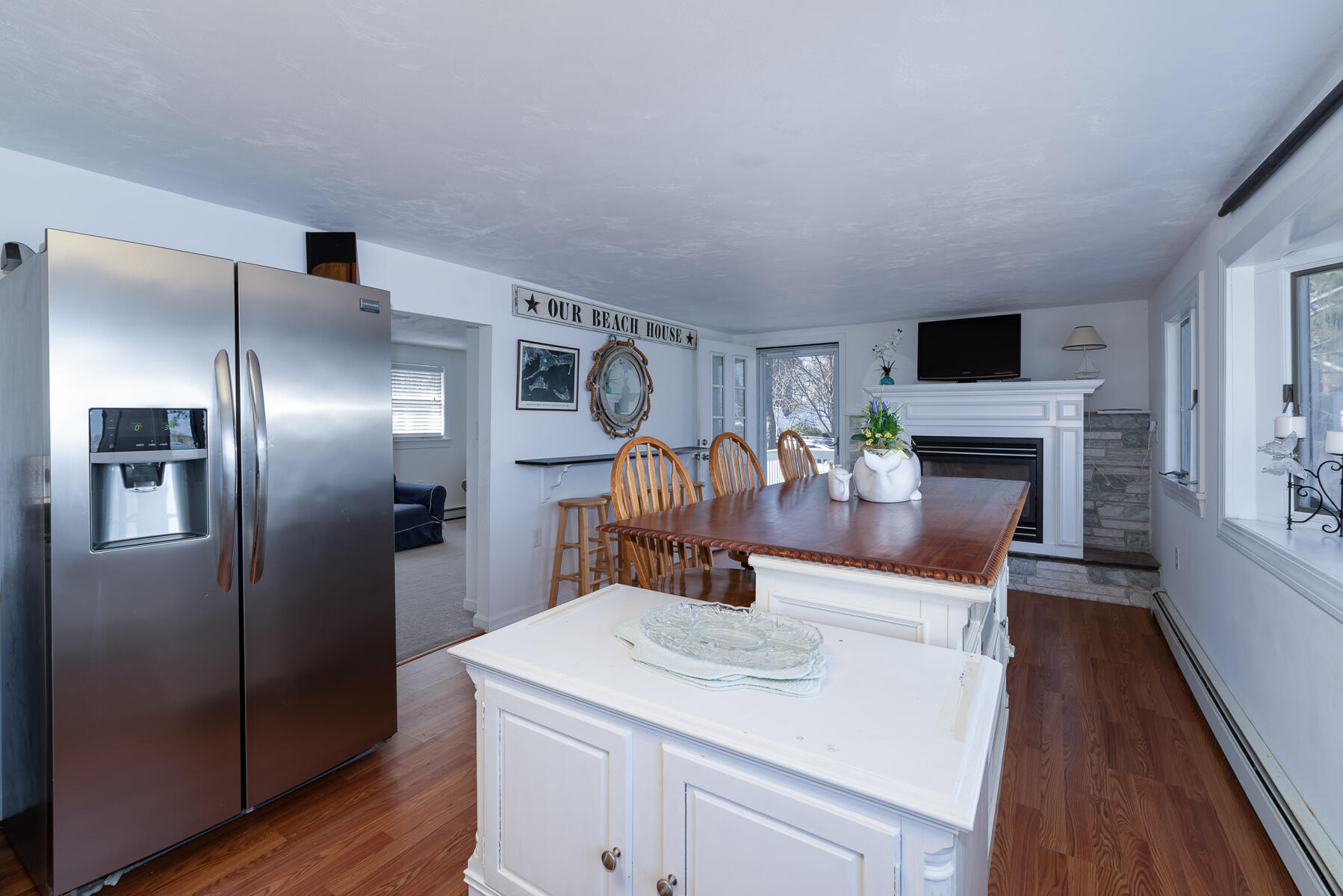 18 Great River Road Mashpee, MA 02649 - Photo 7 of 31 a kitchen with stainless steel appliances a refrigerator and a fireplace