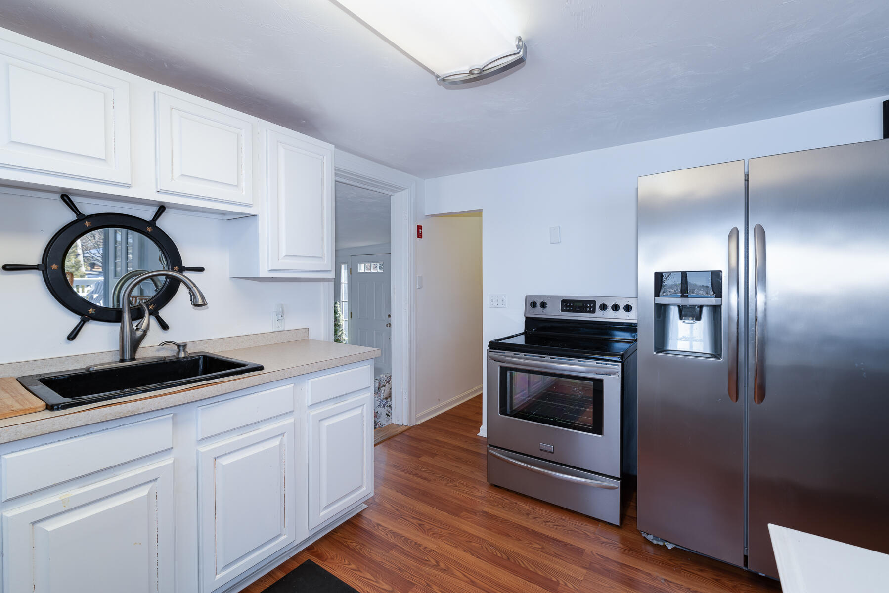 18 Great River Road Mashpee, MA 02649 - Photo 8 of 31 a kitchen with kitchen island stainless steel appliances a stove a sink and cabinets