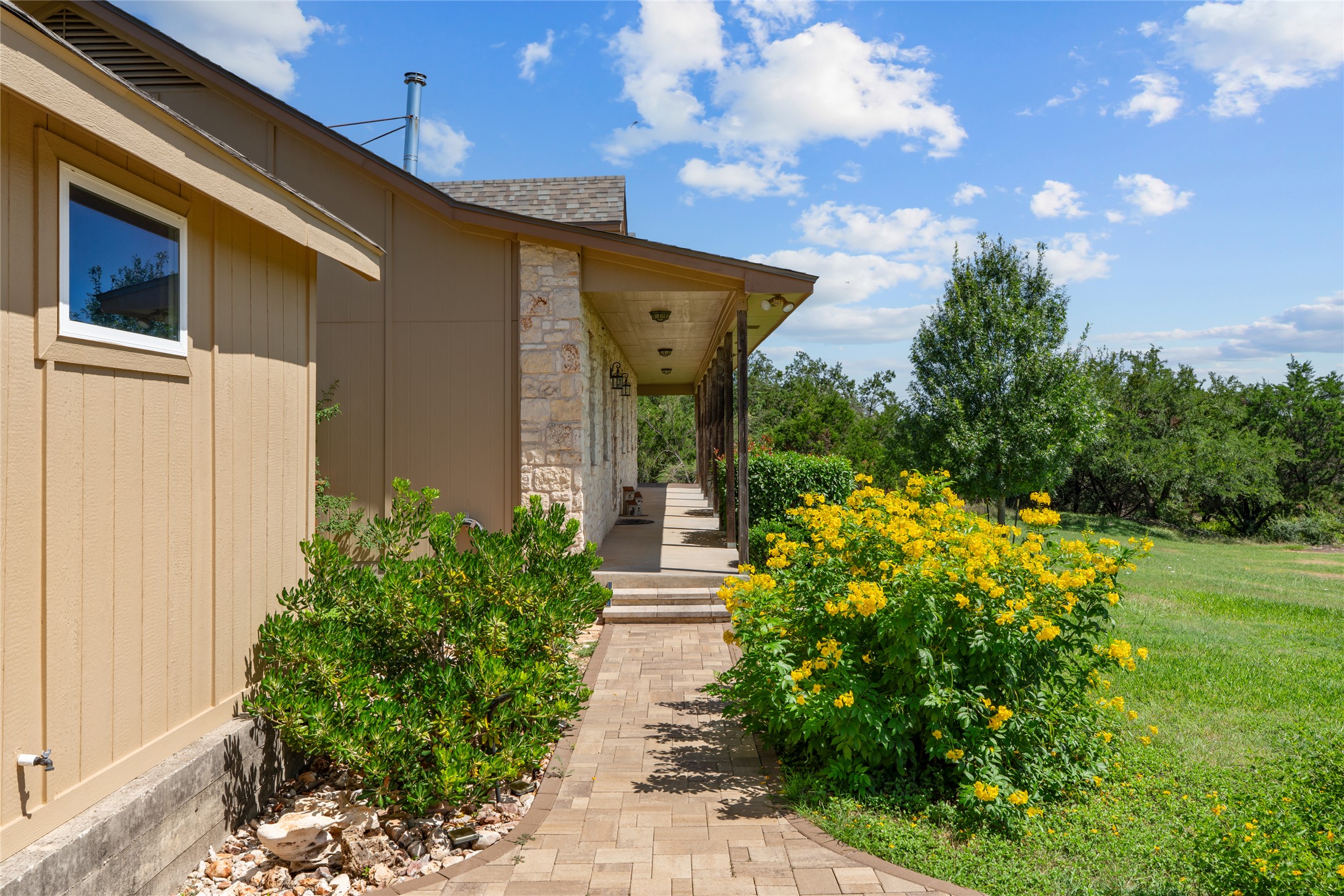 221 Chaparral Road Georgetown, TX 78628 - Photo 27 of 28 Walkway to the covered porch which runs the length of the home