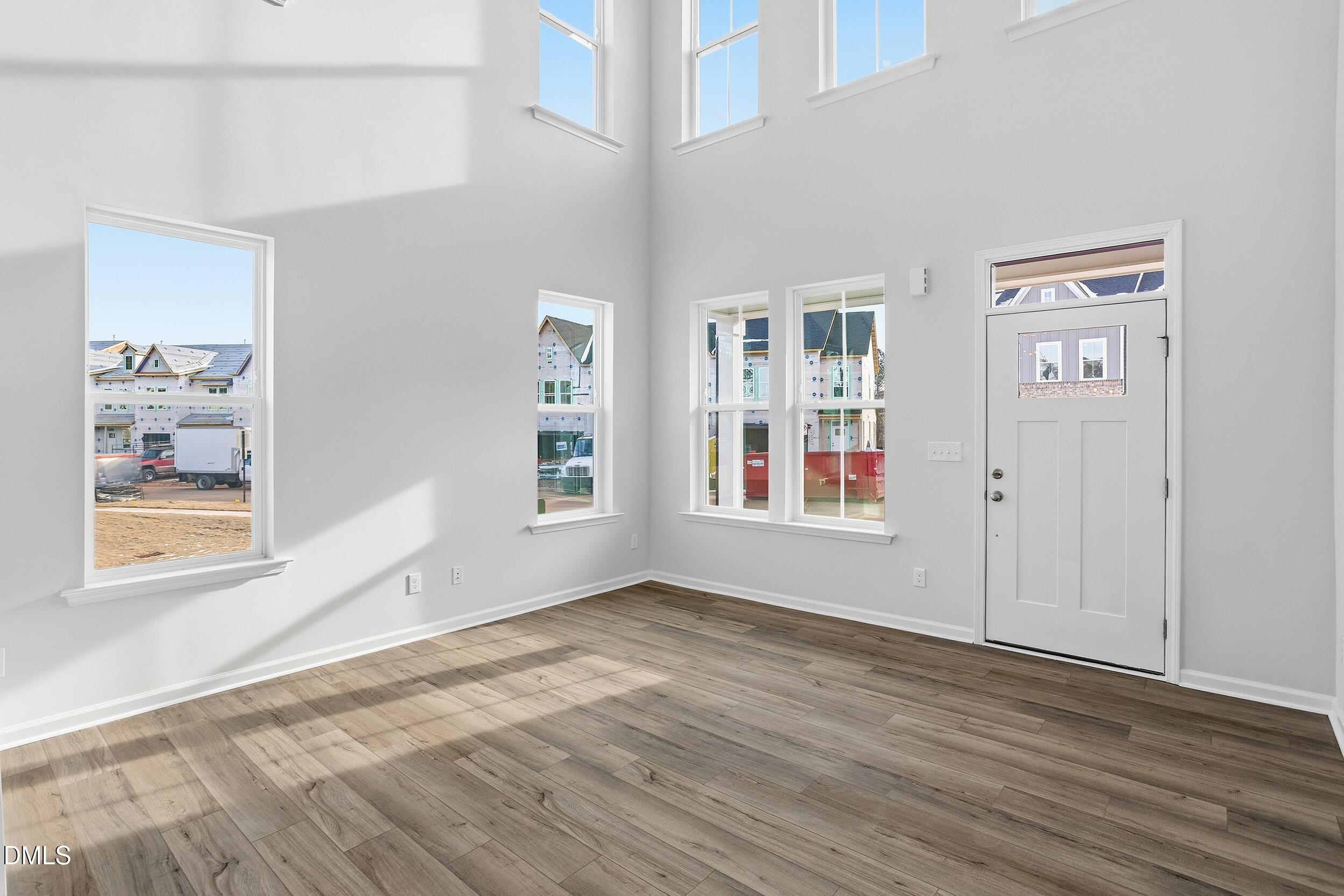 1209 Bell Heather Road, Unit 20 Durham, NC 27703 - Photo 9 of 23 a view of an empty room with window and wooden floor