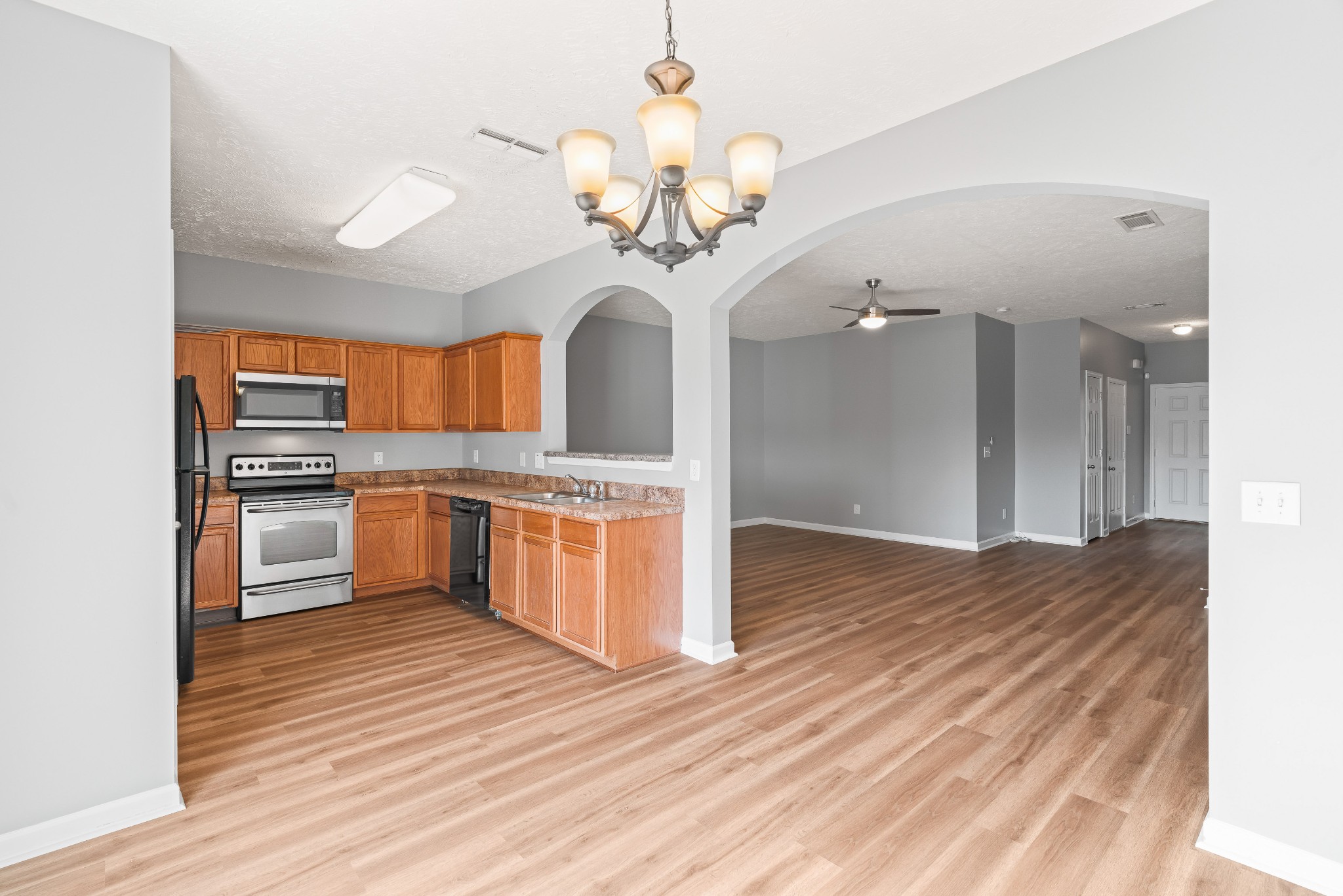 8324 Rossi Road, Unit 8324 Brentwood, TN 37027 - Photo 23 of 41 a kitchen with stainless steel appliances granite countertop a sink cabinets and wooden floor