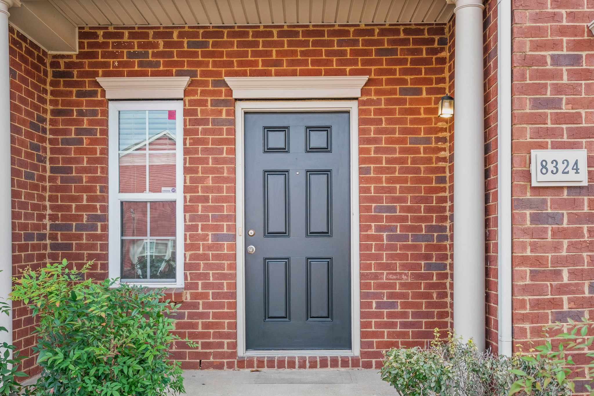8324 Rossi Road, Unit 8324 Brentwood, TN 37027 - Photo 3 of 41 a front view of a building with a garden and entryway