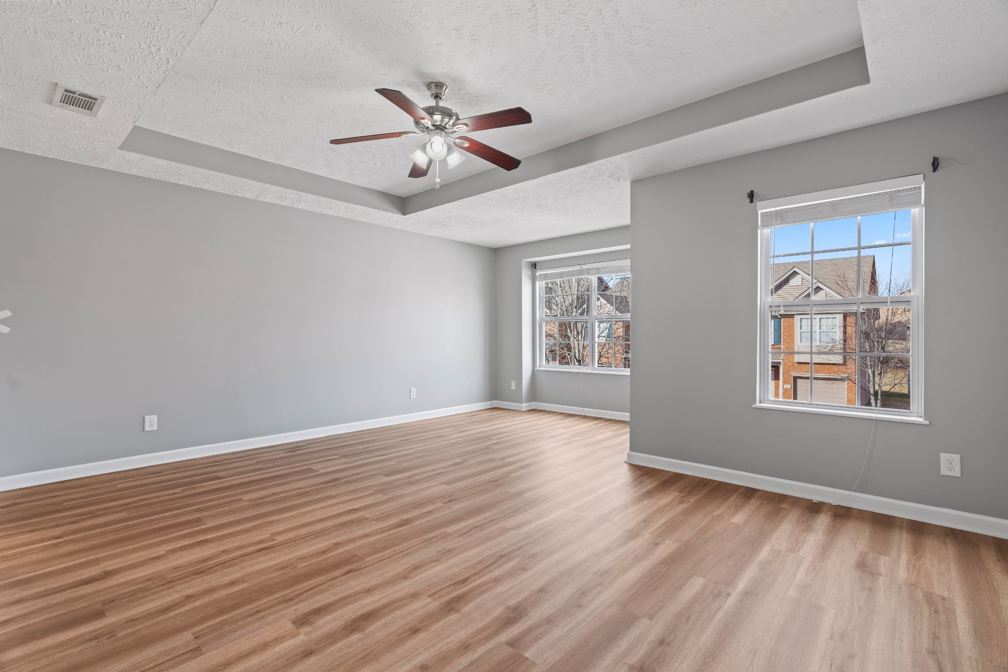 8324 Rossi Road, Unit 8324 Brentwood, TN 37027 - Photo 5 of 41 a view of an empty room with wooden floor and a window