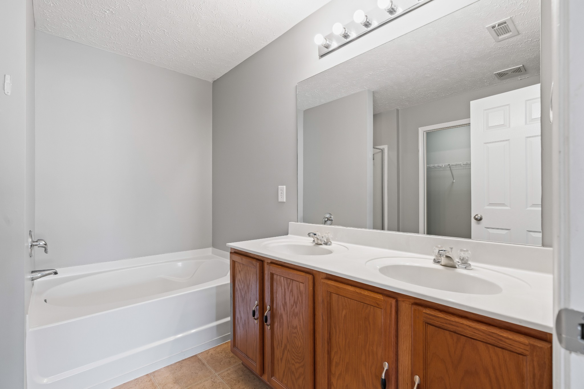 8324 Rossi Road, Unit 8324 Brentwood, TN 37027 - Photo 8 of 41 a bathroom with a tub sink and mirror