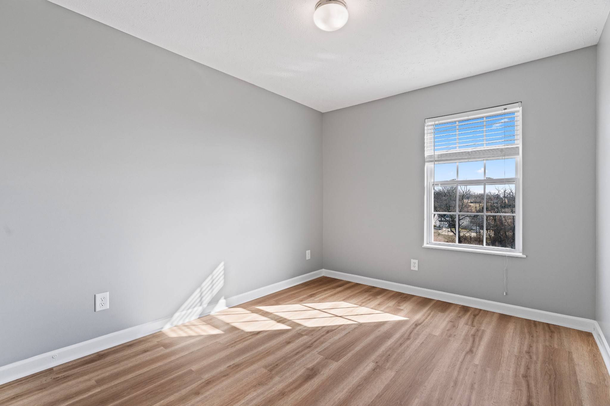 8324 Rossi Road, Unit 8324 Brentwood, TN 37027 - Photo 10 of 41 a view of empty room with wooden floor and fan