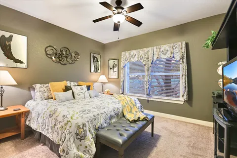 a bedroom with a bed and a chandelier