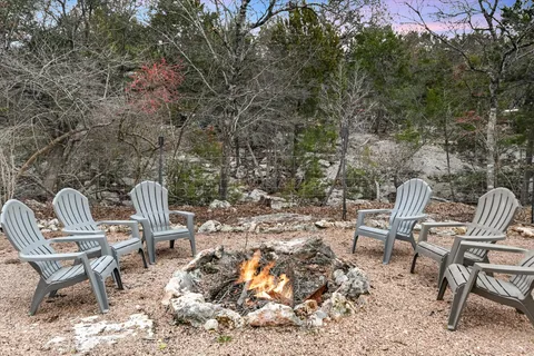 a view of a chairs and table in the backyard