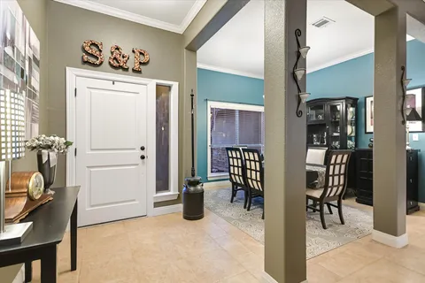 a view of a hallway with workspace and a window