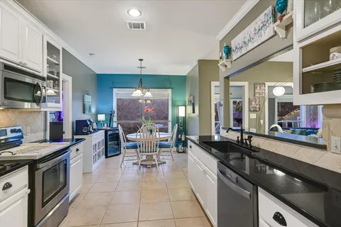 a large kitchen with stainless steel appliances granite countertop a stove and a sink
