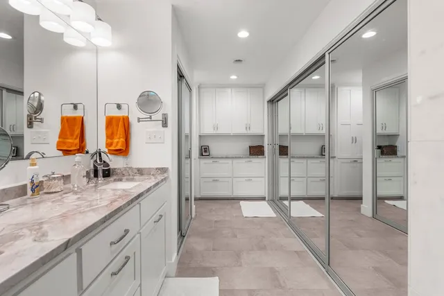a spacious bathroom with a granite countertop sink mirror and shower