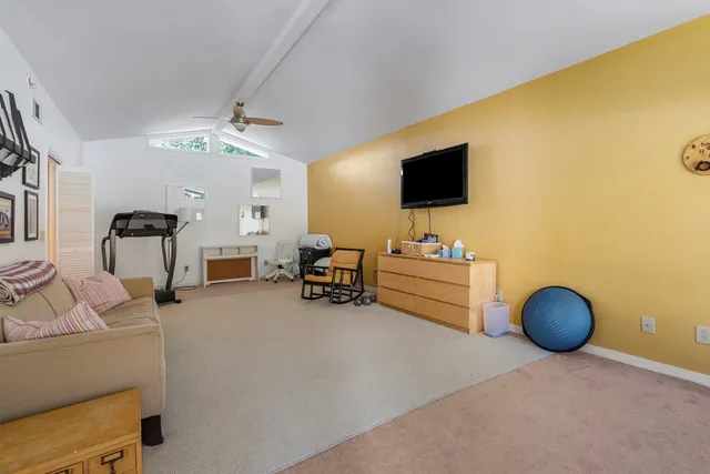 a bedroom with furniture and a flat screen tv