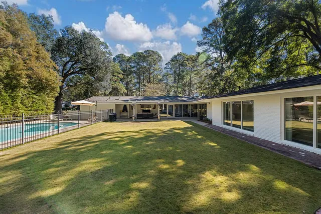 a view of a house with swimming pool and sitting area