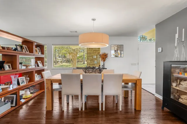 a view of a dining room with furniture and a book shelf