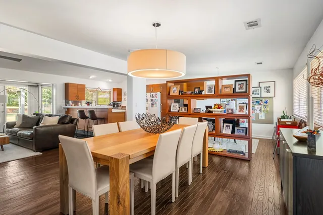 a view of a dining room with furniture and wooden floor
