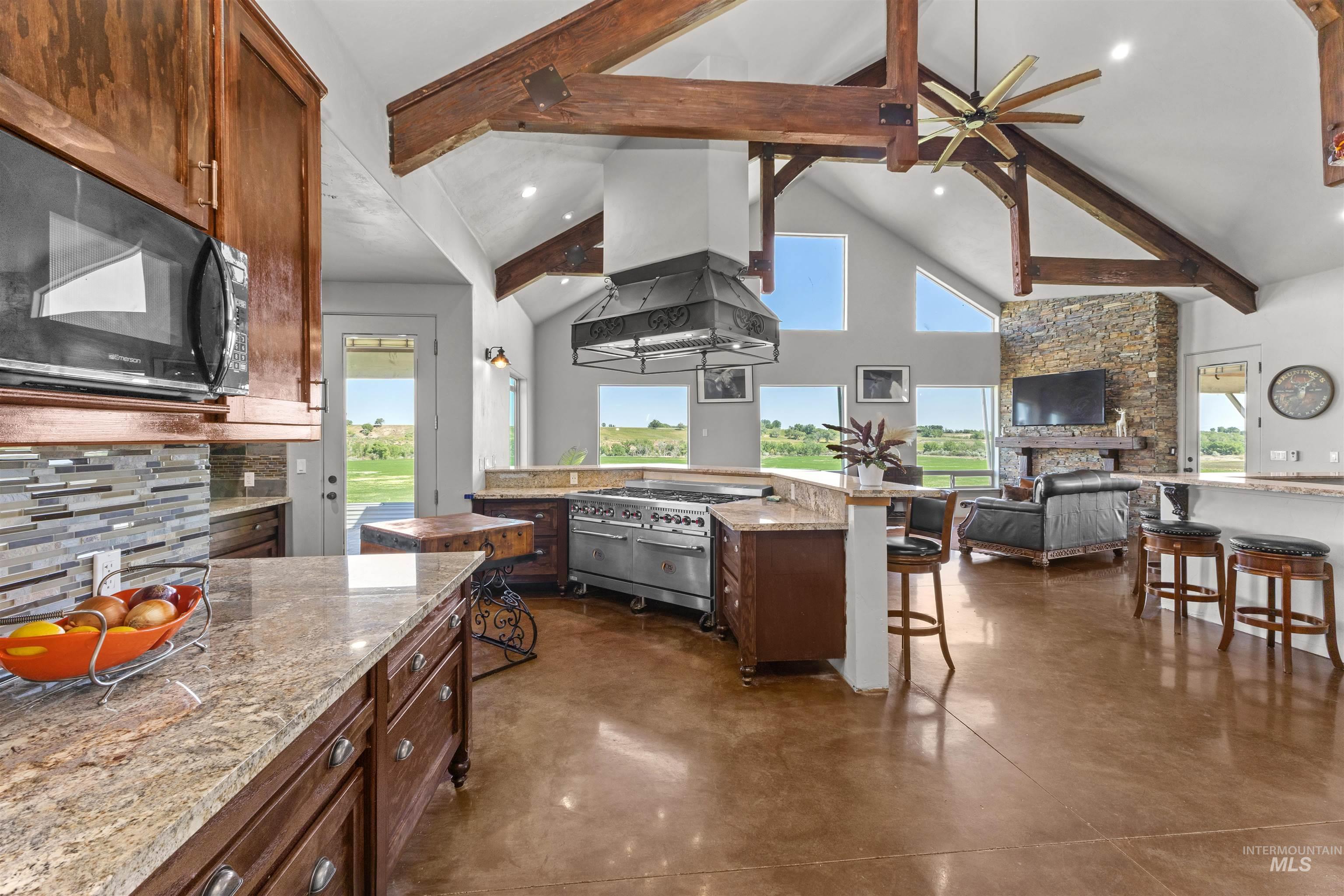 1030 Desert Glen Road Adrian, OR 97901 - Photo 25 of 47 Vaulted ceiling with exposed wood beams and central ceiling fan