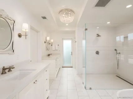 a spacious bathroom with a shower a sink and a mirror