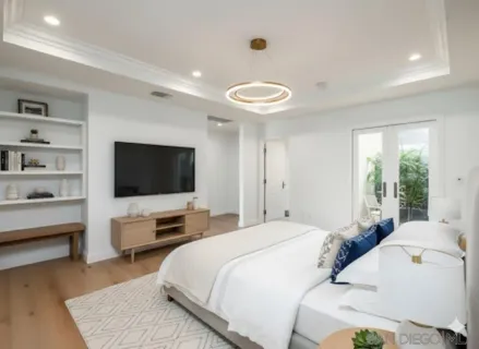 a bedroom with a bed and a flat screen tv