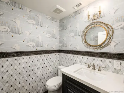 a bathroom with a sink a toilet and a mirror