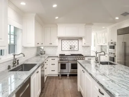 a kitchen with a stove a sink and a refrigerator