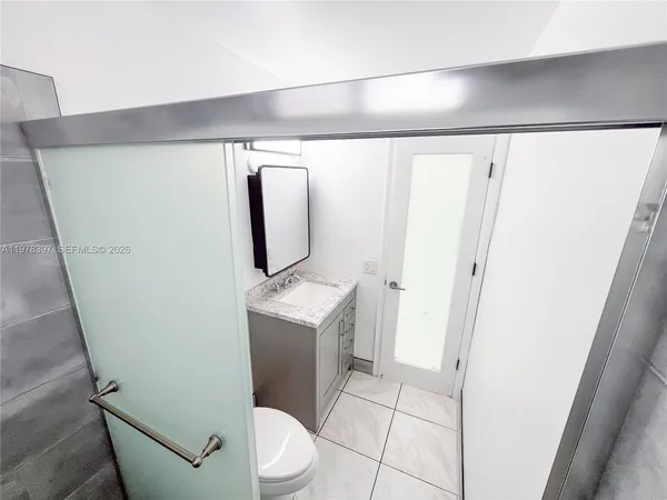 a bathroom with a toilet and a mirror
