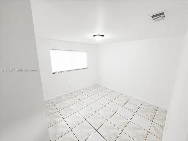 a view of an empty room and window