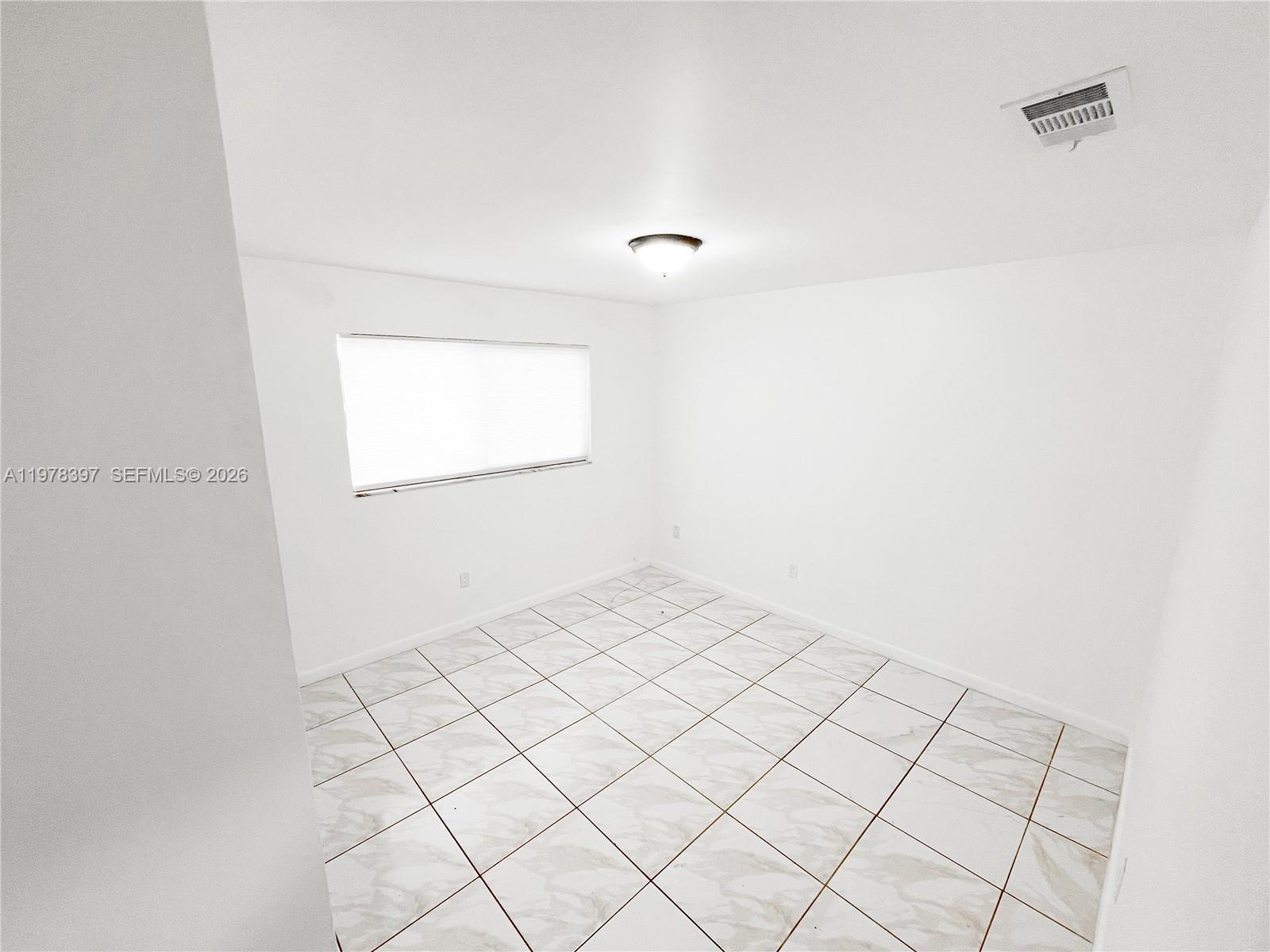 3423 Southwest 3rd Street, Unit 1 Miami, FL 33135 - Photo 13 of 18 a view of an empty room and window