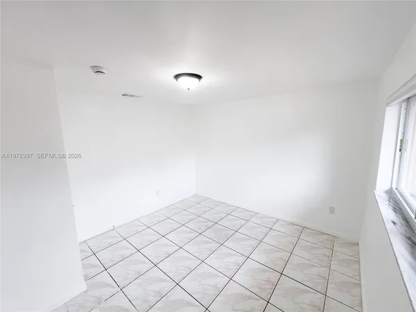 a view of an empty room and window
