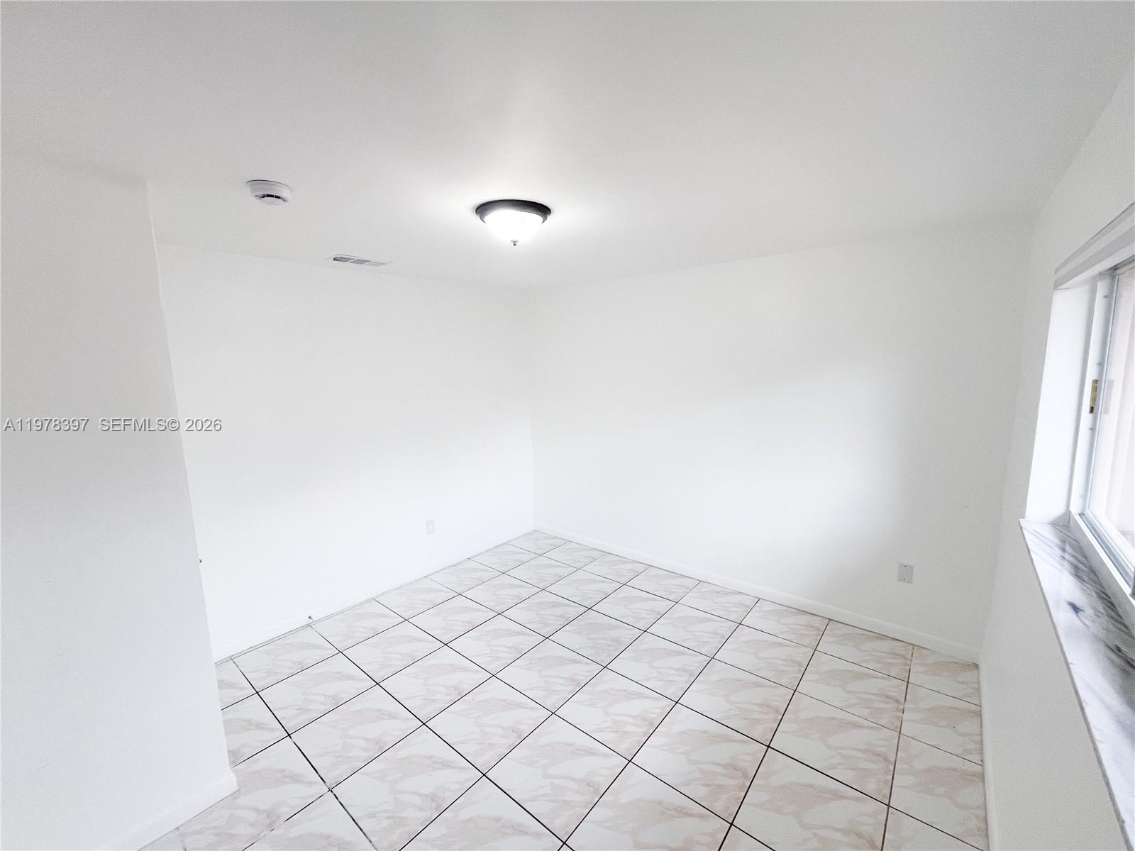 3423 Southwest 3rd Street, Unit 1 Miami, FL 33135 - Photo 15 of 18 a view of an empty room and window