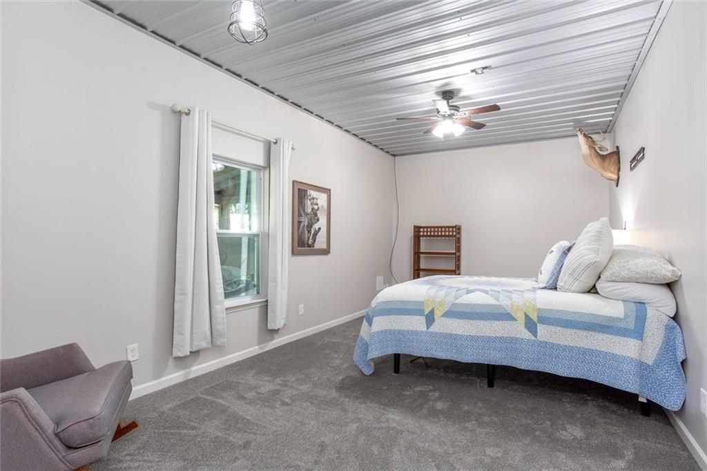 3445 Vinson Mountain Road Rockmart, GA 30153 - Photo 12 of 40 a bedroom with a bed and a chandelier