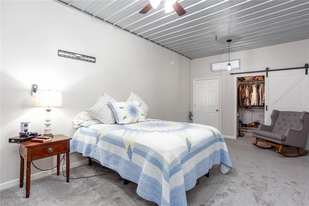 3445 Vinson Mountain Road Rockmart, GA 30153 - Photo 13 of 40 a spacious bedroom with a bed and a couch