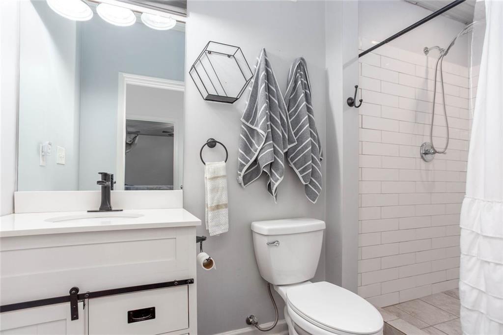 3445 Vinson Mountain Road Rockmart, GA 30153 - Photo 14 of 40 a bathroom with a toilet sink and shower
