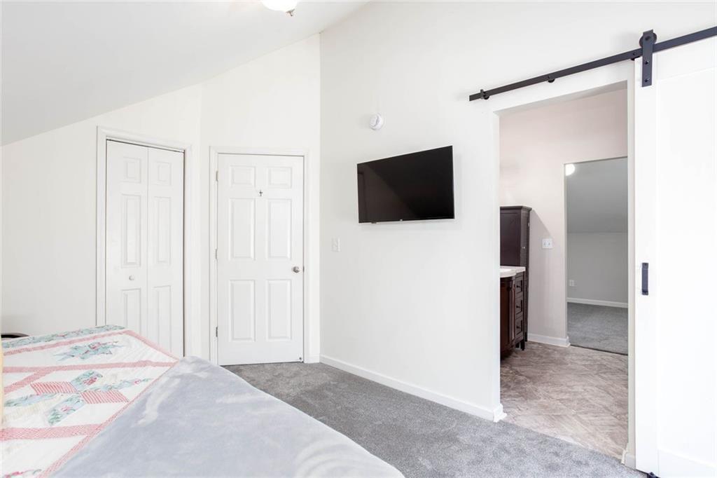 3445 Vinson Mountain Road Rockmart, GA 30153 - Photo 28 of 40 a view of a bedroom with a flat screen tv