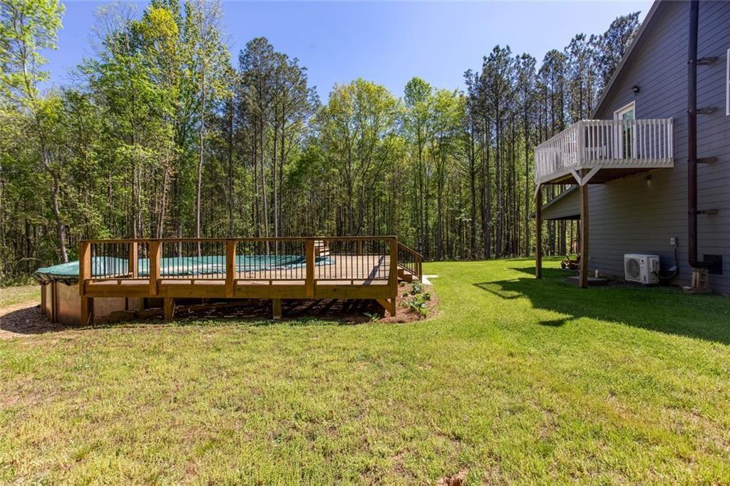 3445 Vinson Mountain Road Rockmart, GA 30153 - Photo 33 of 40 a view of a backyard with a garden and trees