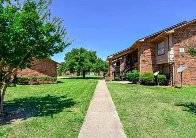 a view of a building with a yard