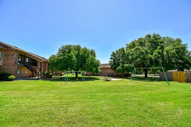 a view of a park with large trees