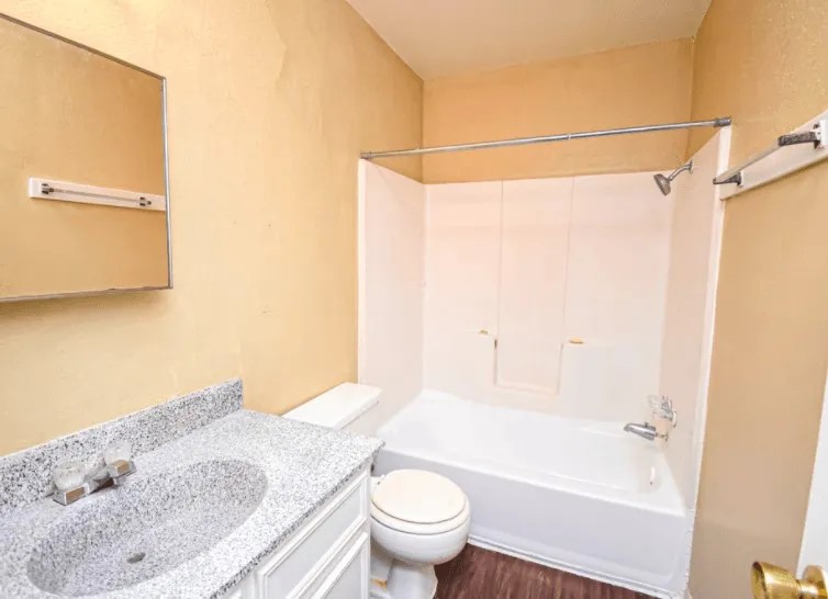 1845 5th Street Hempstead, TX 77445 - Photo 10 of 10 a bathroom with a granite countertop sink toilet and shower