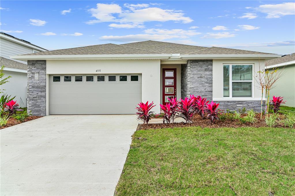 4331 Southern Vista Loop St. Cloud, FL 34772 - Photo 1 of 1 a front view of a house with a yard