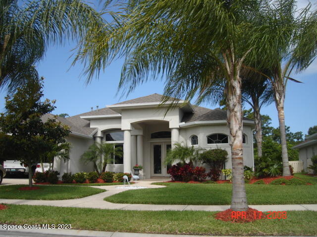 a front view of house with yard and green space