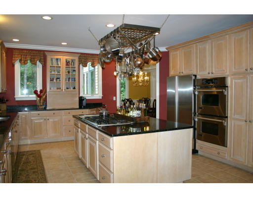28 Moore Road Sudbury, MA 01776 - Photo 8 of 21 a kitchen with stainless steel appliances granite countertop a sink a stove and a refrigerator