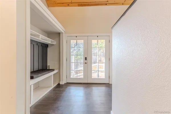 a view of hallway with stairs and wooden floor