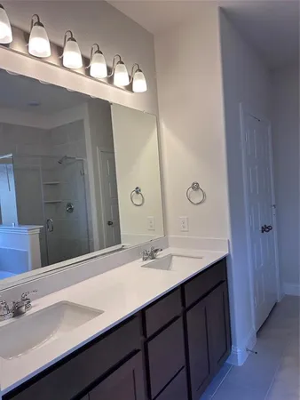 a bathroom with a double vanity sink and a mirror
