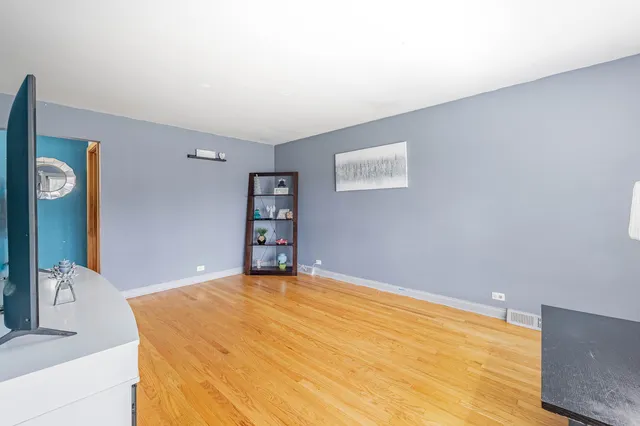 a bedroom with a bed and a dresser in it